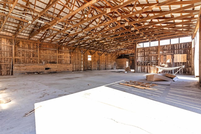 miscellaneous room featuring a garage and vaulted ceiling