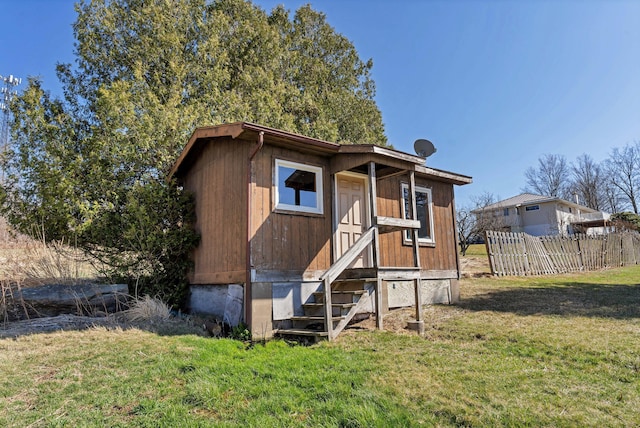 view of front of house with a front yard and fence