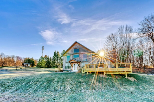 rear view of property with a yard and a deck
