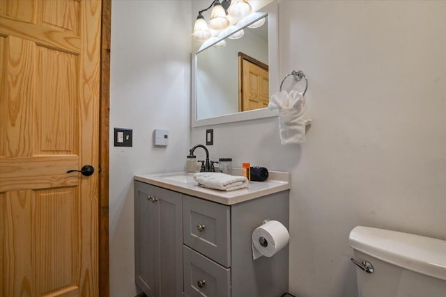 half bathroom with toilet and vanity