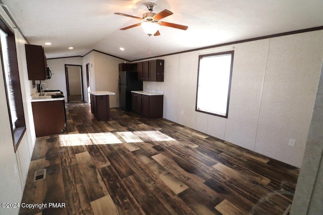 kitchen featuring dark brown cabinetry, visible vents, light countertops, black appliances, and dark wood finished floors