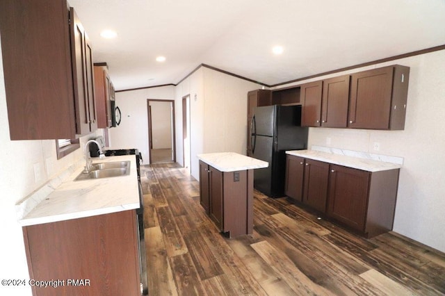 kitchen featuring dark wood-style floors, ornamental molding, a center island, black appliances, and a sink