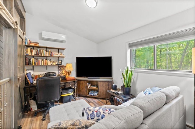 1237 Brentwood Dr, East Stroudsburg, PA 18301 - living area featuring a wall mounted AC, lofted ceiling, wood finished floors, and a desk