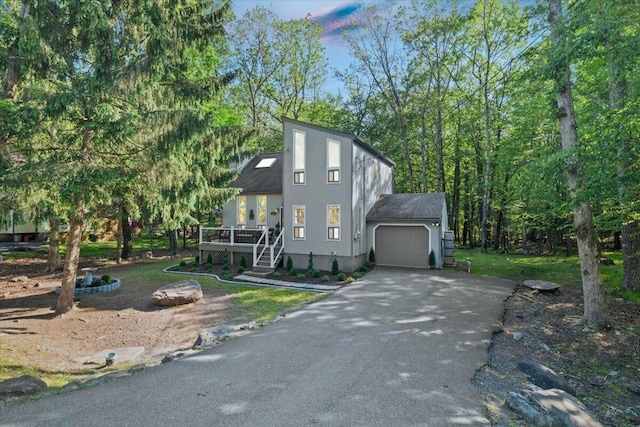 1237 Brentwood Dr, East Stroudsburg, PA 18301 - view of front facade with asphalt driveway, an attached garage, and a deck