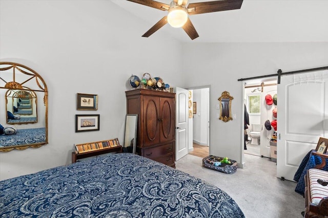 1237 Brentwood Dr, East Stroudsburg, PA 18301 - carpeted bedroom with high vaulted ceiling, a barn door, ensuite bath, and ceiling fan