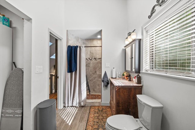 1237 Brentwood Dr, East Stroudsburg, PA 18301 - bathroom with a tile shower, vanity, toilet, and wood finished floors