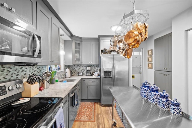 1237 Brentwood Dr, East Stroudsburg, PA 18301 - kitchen featuring stainless steel appliances, gray cabinets, light wood finished floors, backsplash, and stainless steel countertops