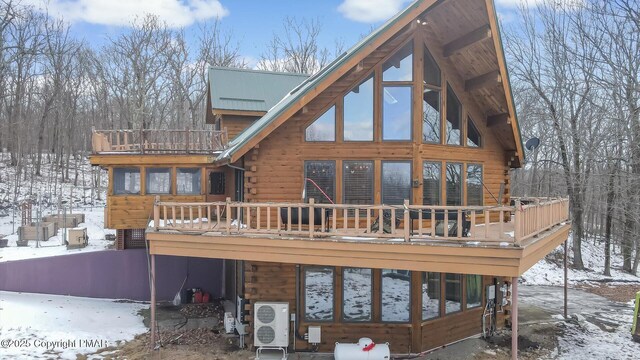 snow covered house featuring a deck