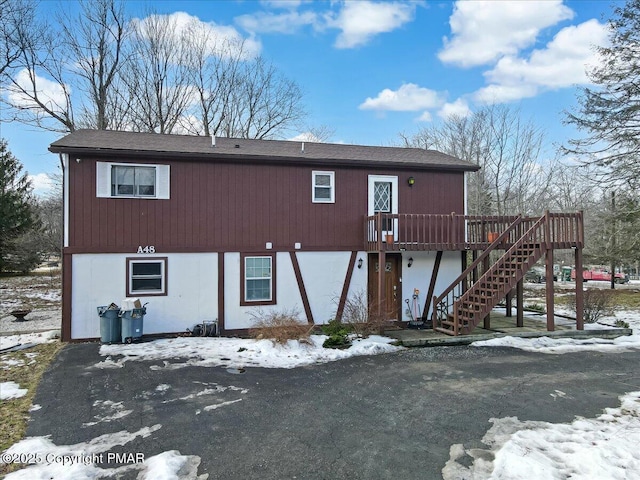 view of front of property with stairway and a wooden deck