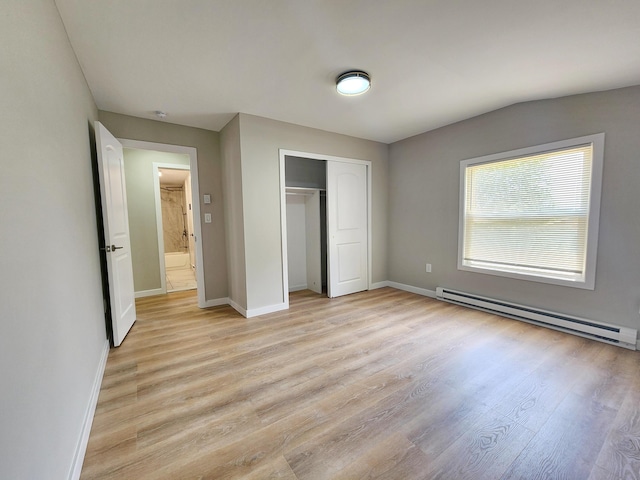 3546 High Hill Rd, Effort, PA 18330 - unfurnished bedroom with a baseboard heating unit, light wood-style flooring, and a closet
