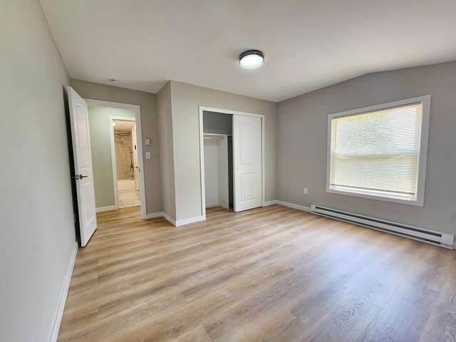 3546 High Hill Rd, Effort, PA 18330 - unfurnished bedroom with a baseboard heating unit, light wood-style flooring, and a closet