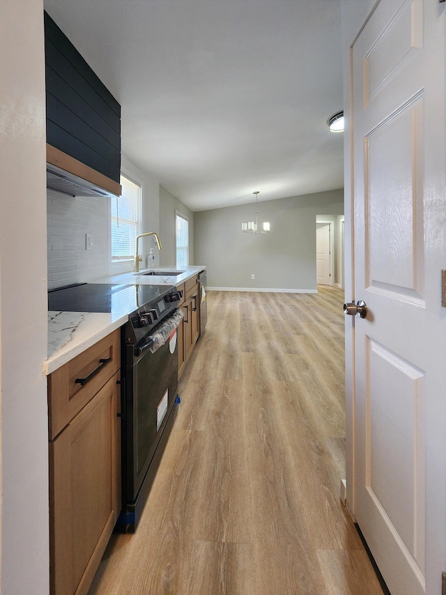 3546 High Hill Rd, Effort, PA 18330 - kitchen featuring black range with electric cooktop, light wood-style floors, a chandelier, tasteful backsplash, and brown cabinets