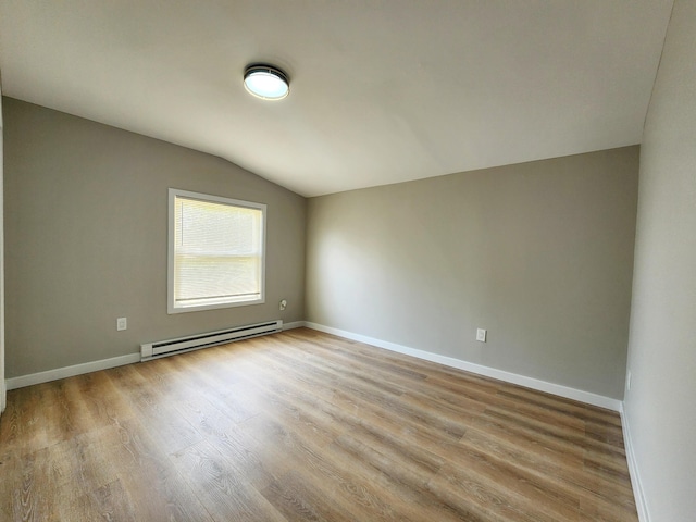 3546 High Hill Rd, Effort, PA 18330 - spare room featuring a baseboard radiator, vaulted ceiling, and wood finished floors