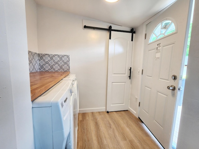 3546 High Hill Rd, Effort, PA 18330 - foyer with independent washer and dryer, light wood-type flooring, and a barn door
