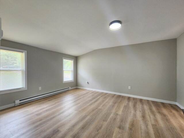 3546 High Hill Rd, Effort, PA 18330 - empty room with baseboard heating, vaulted ceiling, and light wood-style floors