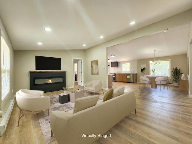 3546 High Hill Rd, Effort, PA 18330 - living area with light wood-style floors, a glass covered fireplace, recessed lighting, and a chandelier