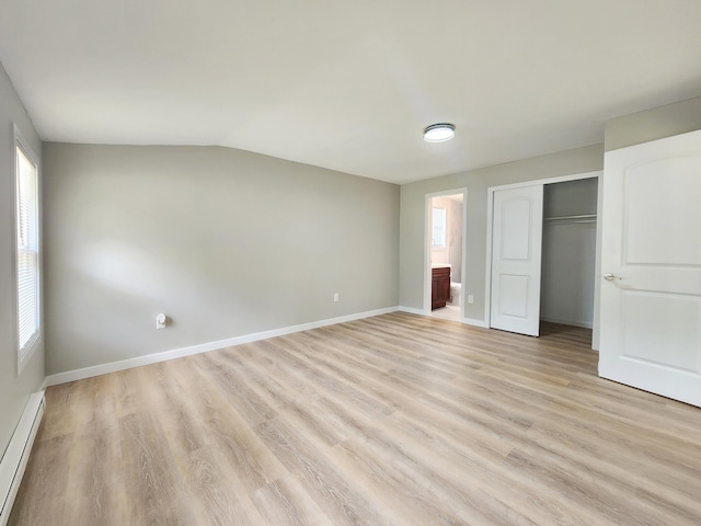 3546 High Hill Rd, Effort, PA 18330 - unfurnished bedroom featuring a baseboard heating unit, multiple windows, light wood finished floors, and lofted ceiling