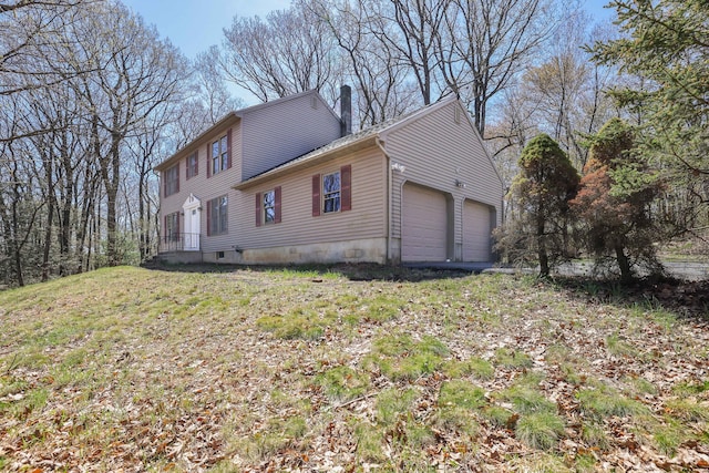 view of side of home with an attached garage