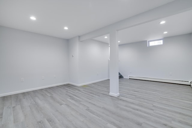 basement with baseboard heating, recessed lighting, baseboards, wood finished floors, and stairway