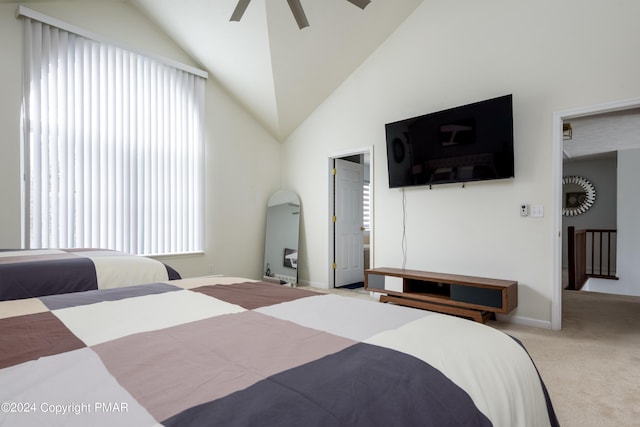 carpeted bedroom featuring a ceiling fan and vaulted ceiling