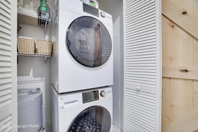 washroom featuring laundry area and stacked washing maching and dryer