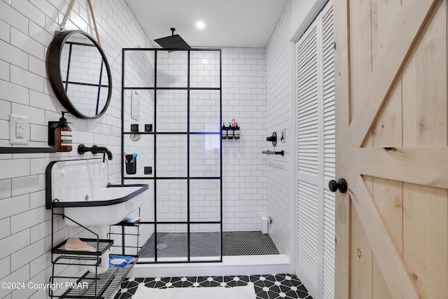 full bathroom with a stall shower and tile walls