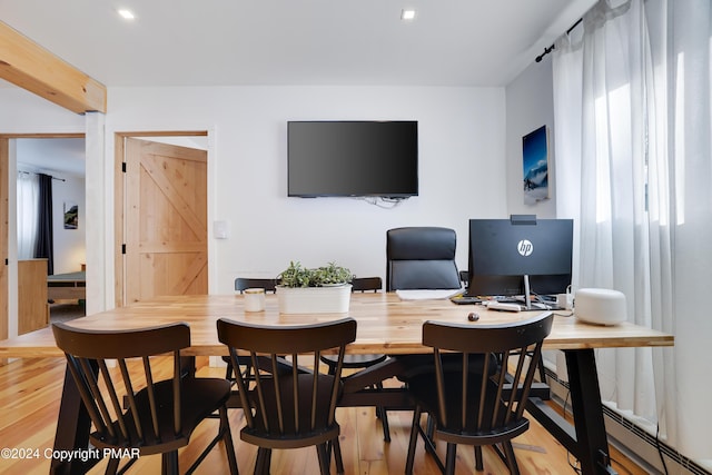 office area featuring light wood-style flooring and a barn door