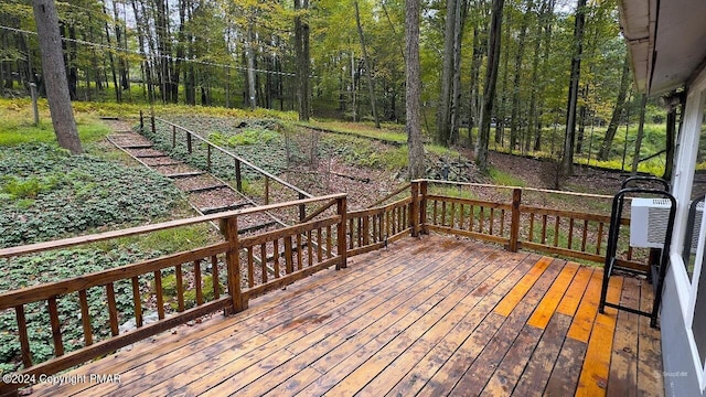 wooden deck featuring a forest view