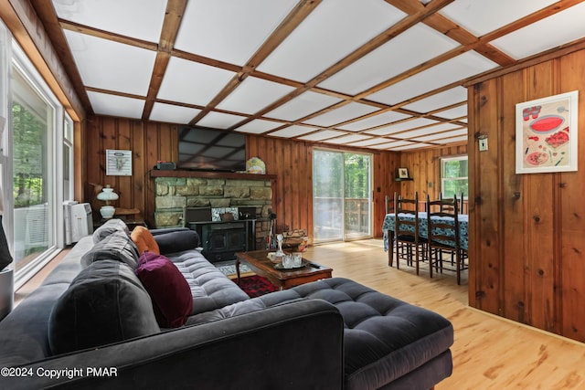 living room with wooden walls, coffered ceiling, and wood finished floors