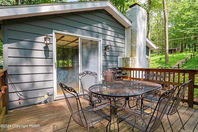 deck featuring outdoor dining area