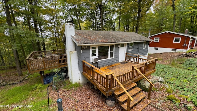 back of property featuring a deck and a chimney