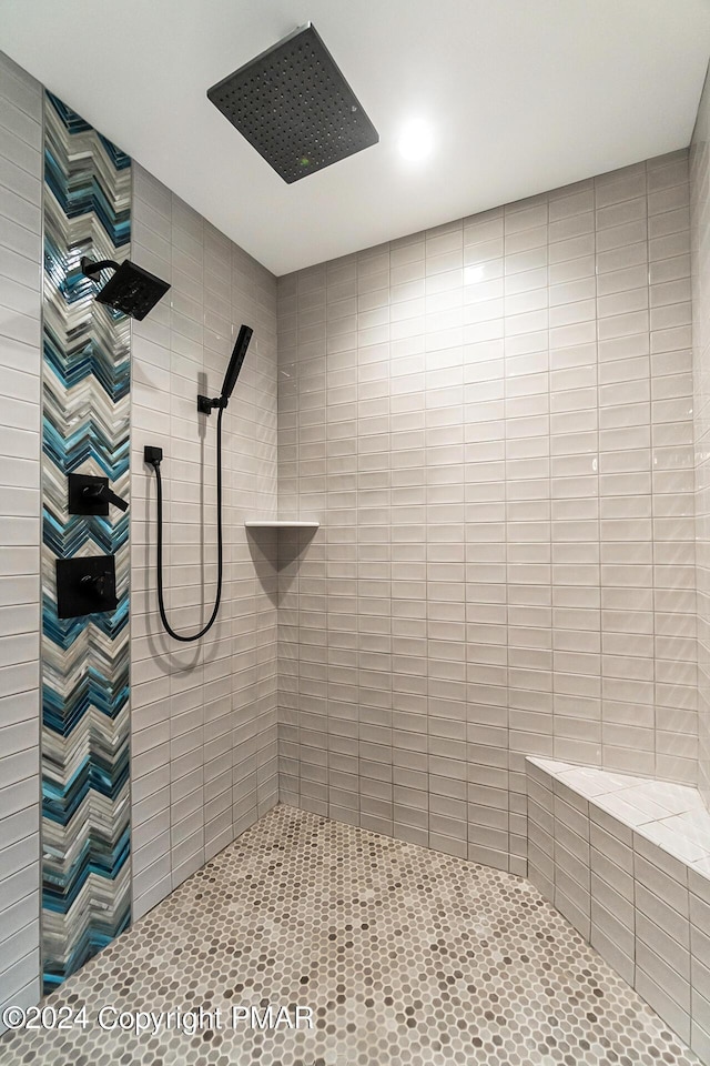 full bath with a tile shower