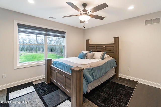 bedroom with baseboards, visible vents, dark wood-type flooring, and recessed lighting