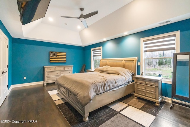 bedroom featuring recessed lighting, a raised ceiling, visible vents, wood finished floors, and baseboards