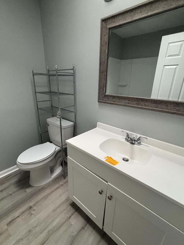 2754 Hedgerow Ln, Stroudsburg, PA 18360 - bathroom featuring wood finished floors, vanity, toilet, and baseboards