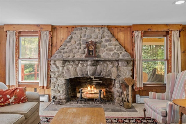 105 Waygood Way, Pocono Pines, PA 18350 - carpeted living room featuring a stone fireplace, wood walls, and baseboard heating