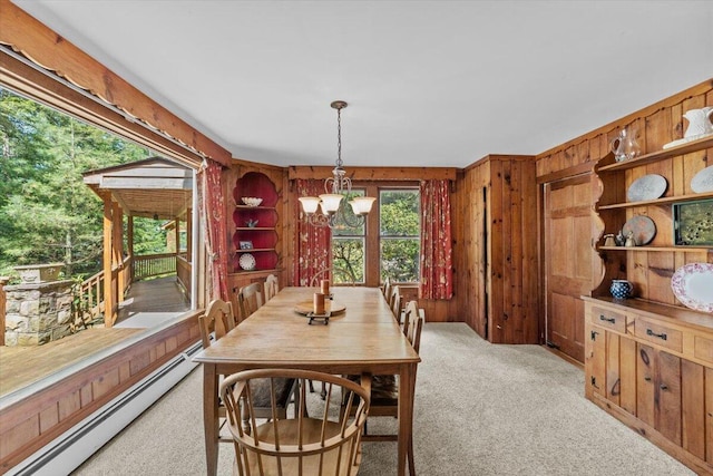 105 Waygood Way, Pocono Pines, PA 18350 - dining area with a baseboard radiator, wooden walls, light carpet, and a chandelier