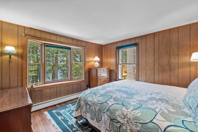 105 Waygood Way, Pocono Pines, PA 18350 - bedroom with a baseboard radiator, wood walls, and wood finished floors