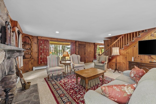 105 Waygood Way, Pocono Pines, PA 18350 - carpeted living area with a baseboard radiator, wood walls, stairs, a fireplace, and recessed lighting