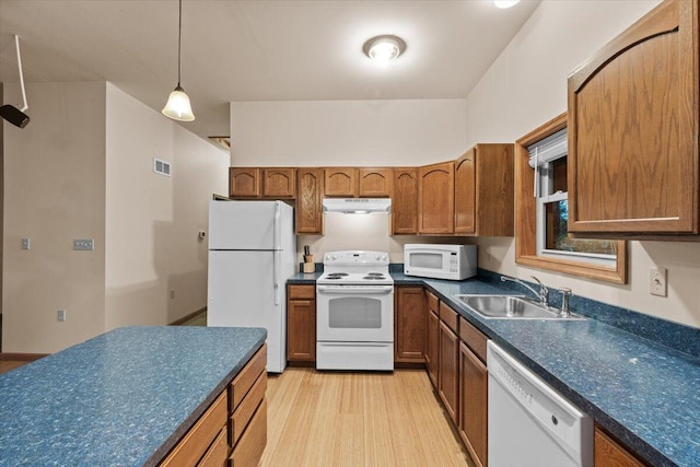 105 Waygood Way, Pocono Pines, PA 18350 - kitchen with white appliances, under cabinet range hood, dark countertops, and brown cabinetry