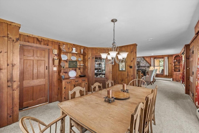 105 Waygood Way, Pocono Pines, PA 18350 - dining space with carpet flooring, wooden walls, a baseboard radiator, and a chandelier