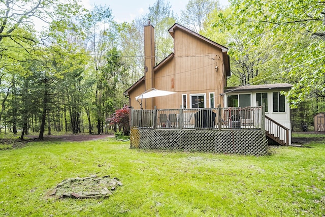 205 Victory Ln, Long Pond, PA 18334 - back of property featuring a chimney, a lawn, a wooden deck, and a sunroom