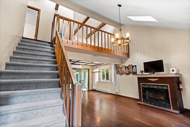 205 Victory Ln, Long Pond, PA 18334 - stairway with a chandelier, a skylight, wood finished floors, a baseboard heating unit, and high vaulted ceiling