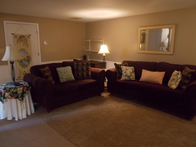 carpeted living area featuring visible vents