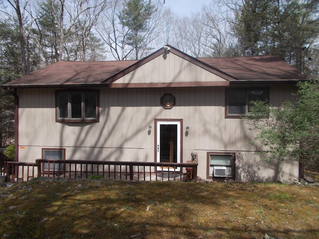 back of property featuring roof with shingles
