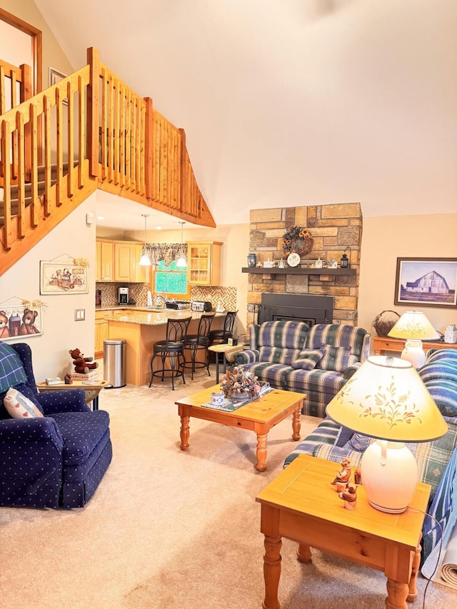 155 Clifton Dr, Bushkill, PA 18324 - living room featuring carpet floors, a stone fireplace, and high vaulted ceiling