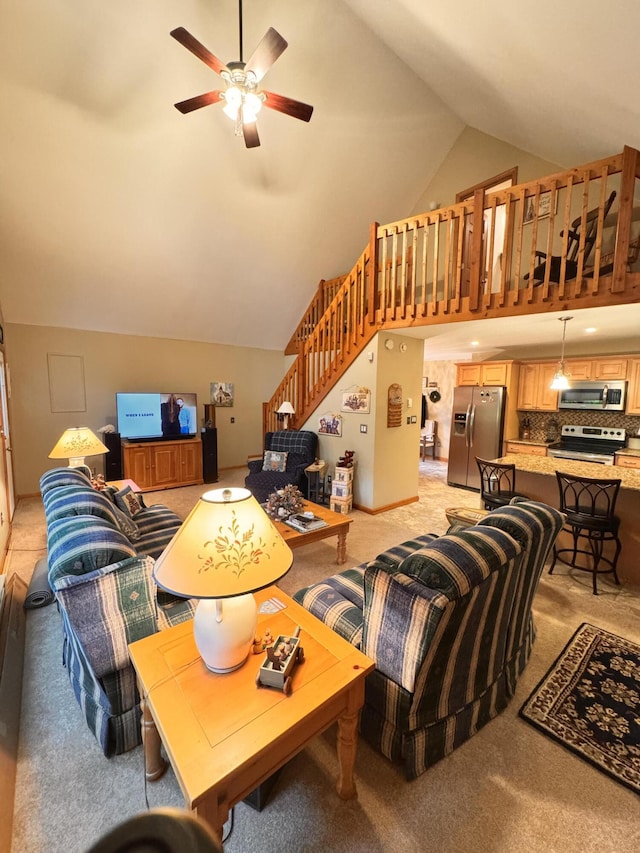 155 Clifton Dr, Bushkill, PA 18324 - living area featuring a ceiling fan, stairway, and high vaulted ceiling