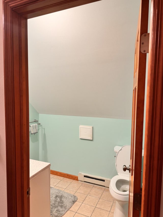 155 Clifton Dr, Bushkill, PA 18324 - bathroom with baseboard heating, tile patterned flooring, toilet, lofted ceiling, and baseboards