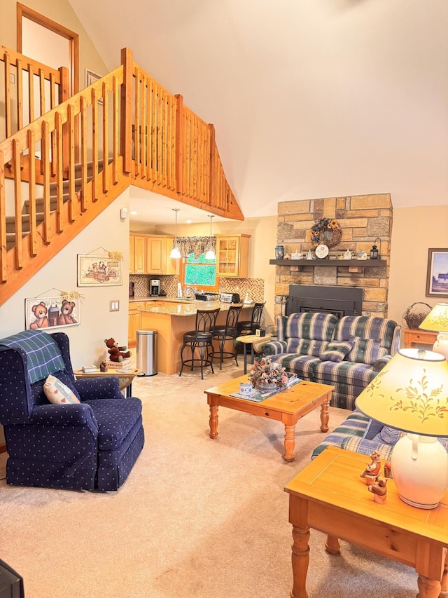 155 Clifton Dr, Bushkill, PA 18324 - living area with carpet flooring, high vaulted ceiling, and a fireplace
