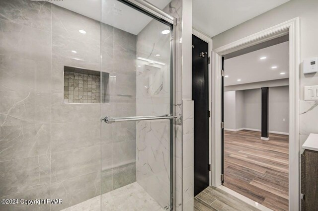 181 Williams Ln, Scotrun, PA 18355 - bathroom featuring a marble finish shower, wood finished floors, recessed lighting, and baseboards